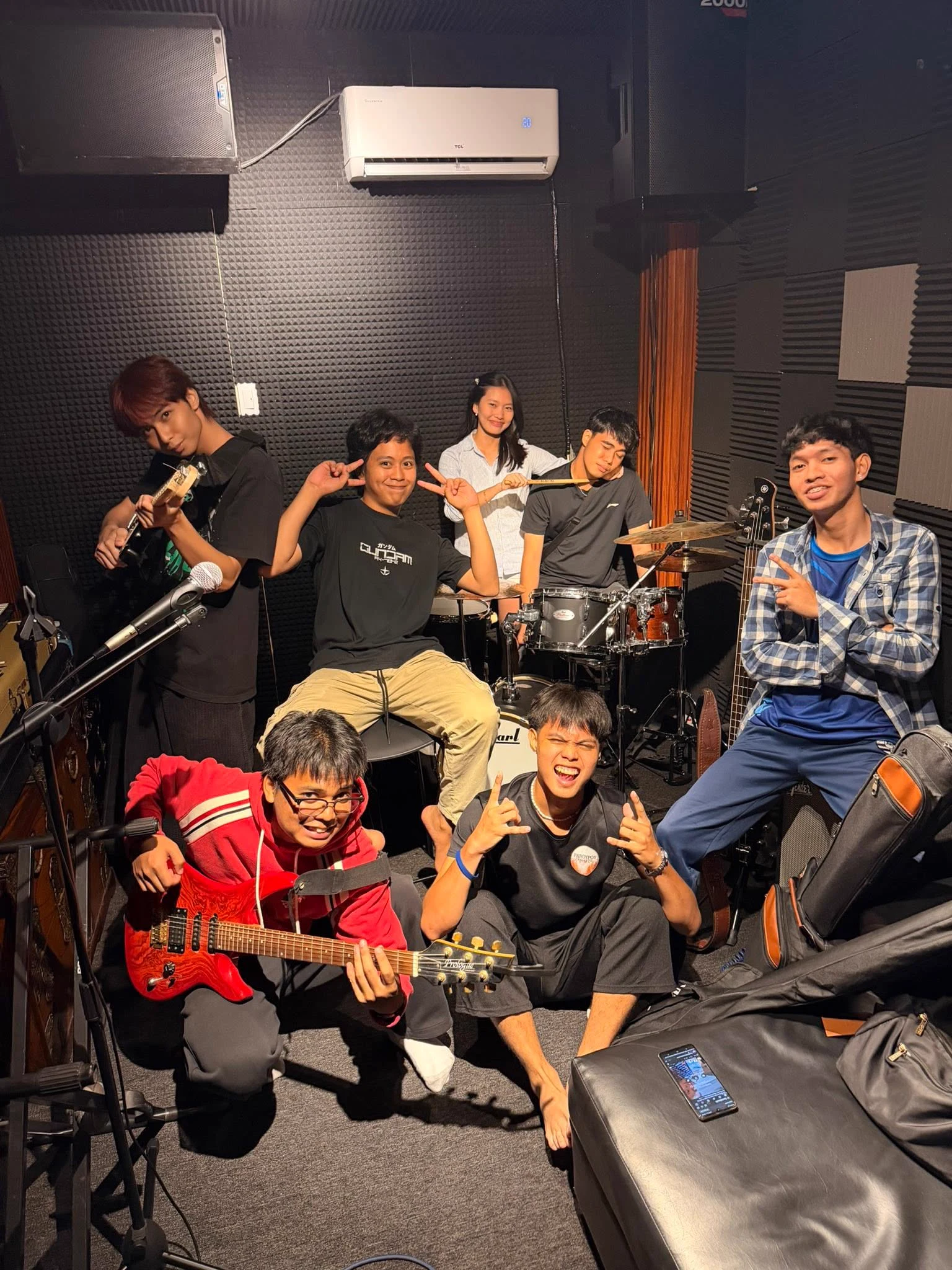 Musicians hanging out with their instruments inside Oido Music Studio