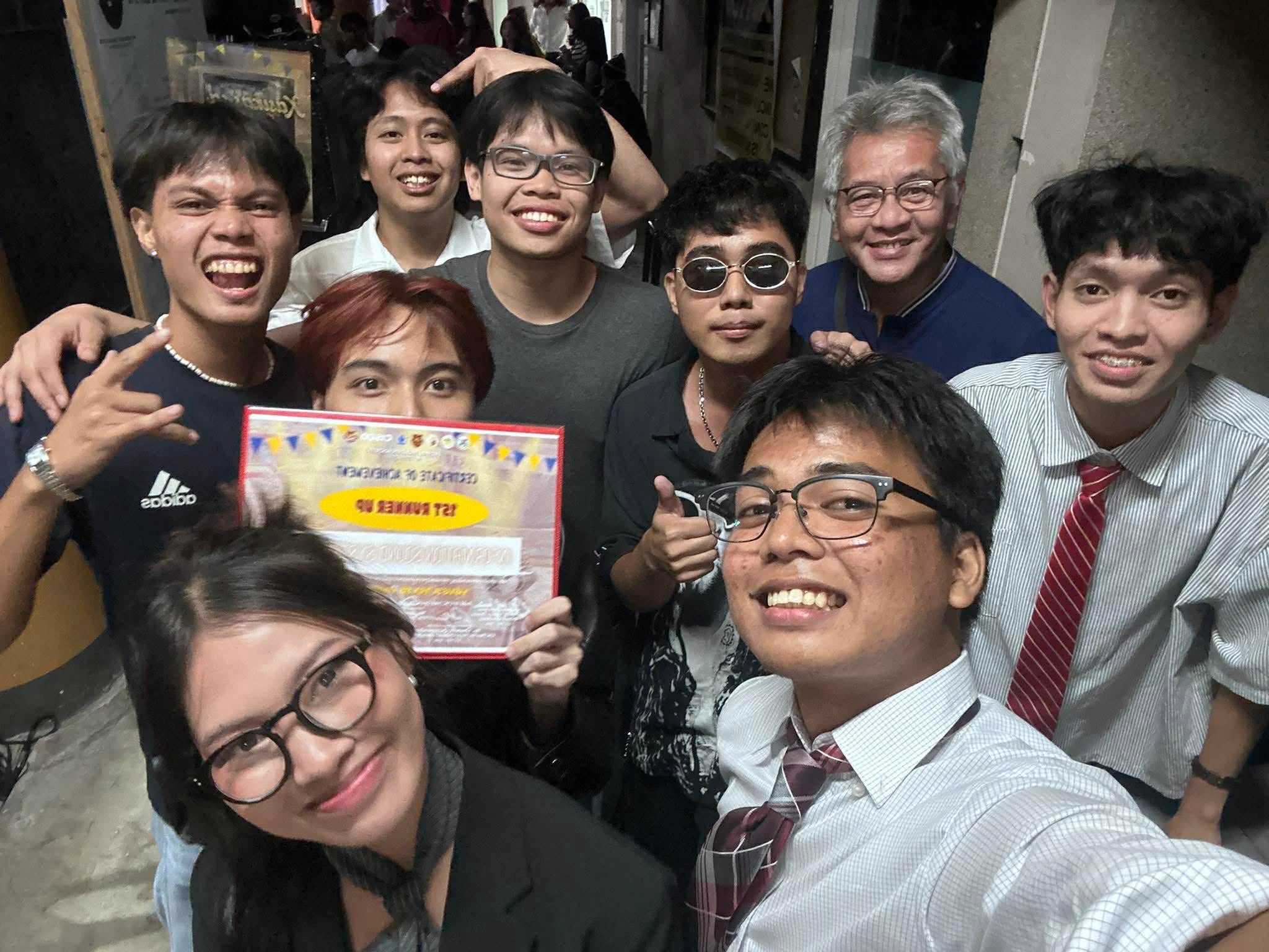Musicians and friends smiling together for a group selfie