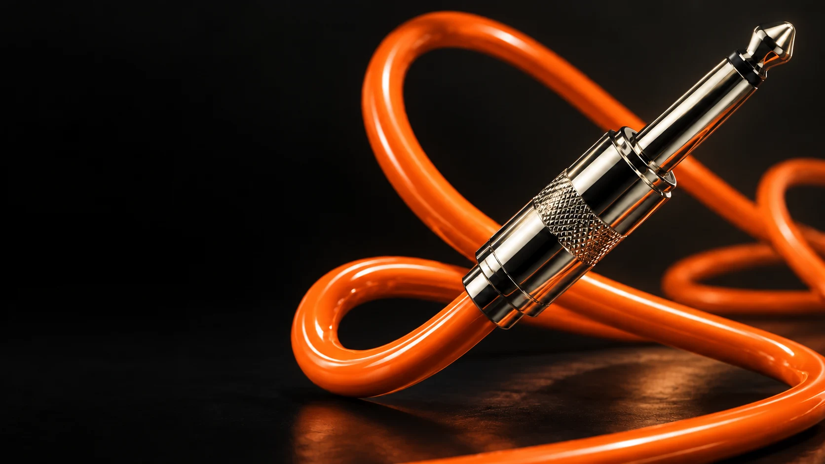 Sculptural chrome guitar jack and looping tangerine-orange cable